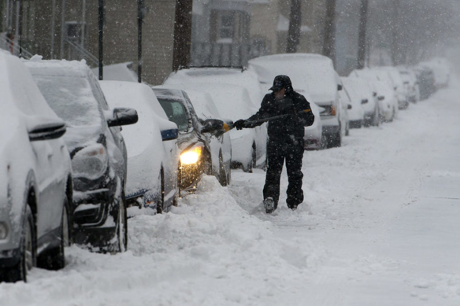 A man removes snow from his car on 15th Street in Bayonne during a snowstorm on Tuesday, Jan. 27, 2015. Reena Rose Sibayan | The Jersey Journal