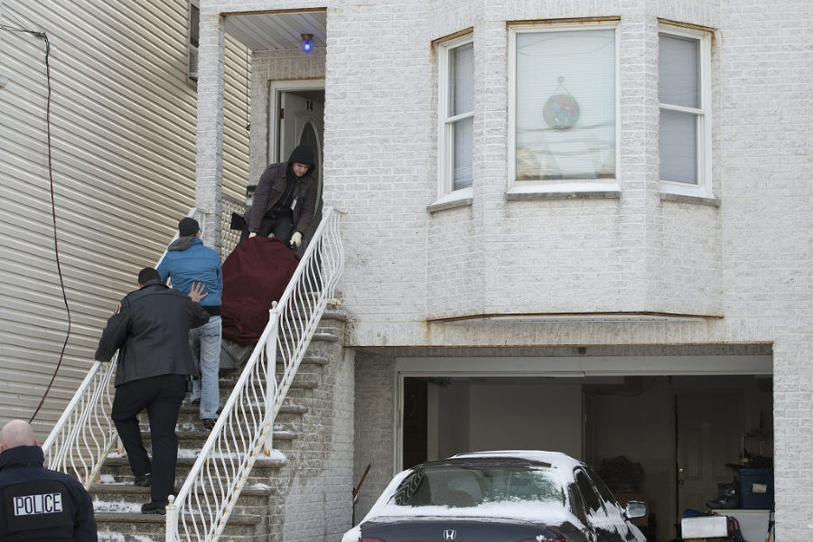 The body of one of two people found dead at 14 W. 10th St. in Bayonne is removed from the house on Tuesday, Jan. 27, 2015. Reena Rose Sibayan | The Jersey Journal