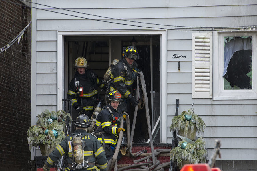 Firefighters battle a five-alarm blaze that ripped through two attached homes in Bayonne at 12 and 14 West 34th St. on Monday, Feb. 16, 2015. Reena Rose Sibayan | The Jersey Journal