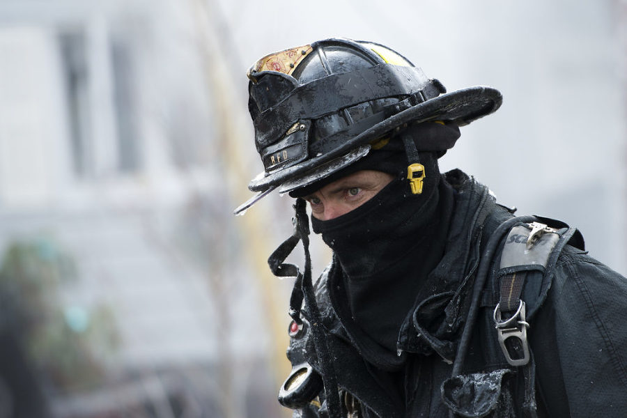Firefighters endure bitter cold as they battle a five-alarm blaze that ripped through two attached homes in Bayonne at 12 and 14 West 34th St. on Monday, Feb. 16, 2015. Reena Rose Sibayan | The Jersey Journal