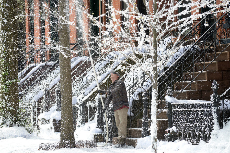 People came upon an unusual springtime sight at West Hamilton Place in Jersey City which was transformed into a winter wonderland as foam is sprayed on trees and sidewalks for a commercial photo shoot on Tuesday, April 21, 2015. Reena Rose Sibayan | The Jersey Journal