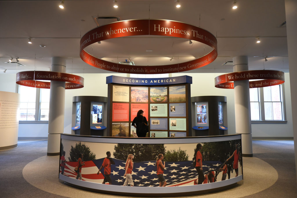 Members of the press preview the new post-Ellis Island wing of The Peopling of America Center called The Journey: New Eras of Immigration which focuses on immigration from 1954 to present times, at the Ellis Island National Museum of Immigration on Thursday, May 7, 2015. Pictured is the Citizenship Gallery. Reena Rose Sibayan | The Jersey Journal