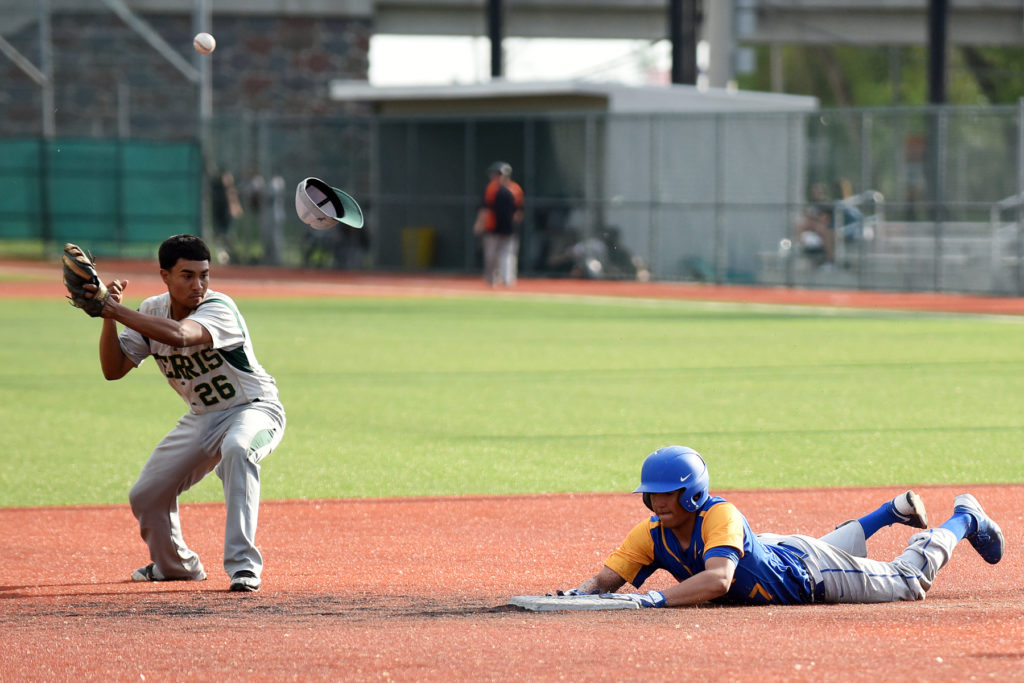 The ball knocks the cap from the head of Joey Colon of Ferris as Marist's Andrew Villacis slides safely into second base during the Hudson County Tournament quarterfinals at Lincoln Park in Jersey City on Tuesday, May 12, 2015. Marist won, 7-4. Reena Rose Sibayan | The Jersey Journal