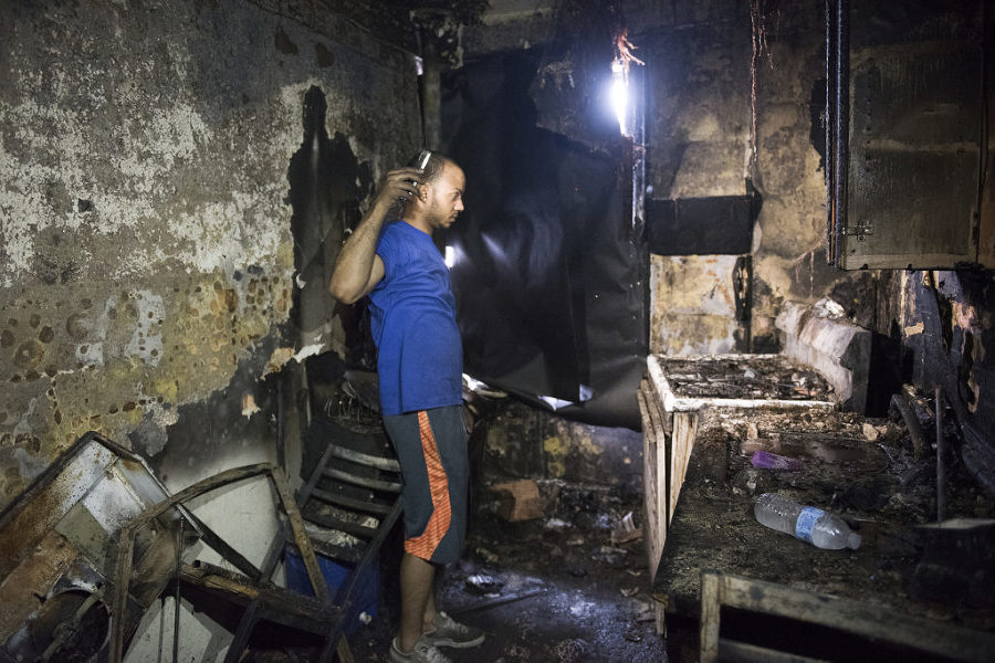 Juan Jose Cid shows the charred kitchen inside his first-floor apartment at 500 Garfield Ave. in Jersey City where the fire is believed to have started, Monday, June 15, 2015. Reena Rose Sibayan | The Jersey Journal