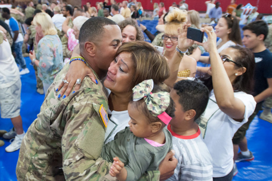 Sgt. Jesse De La Cruz, 29, of Passaic, kisses his mother, Mari Gumann of Vernon, as she holds his daughter, Khloe, who was born just before he was deployed.