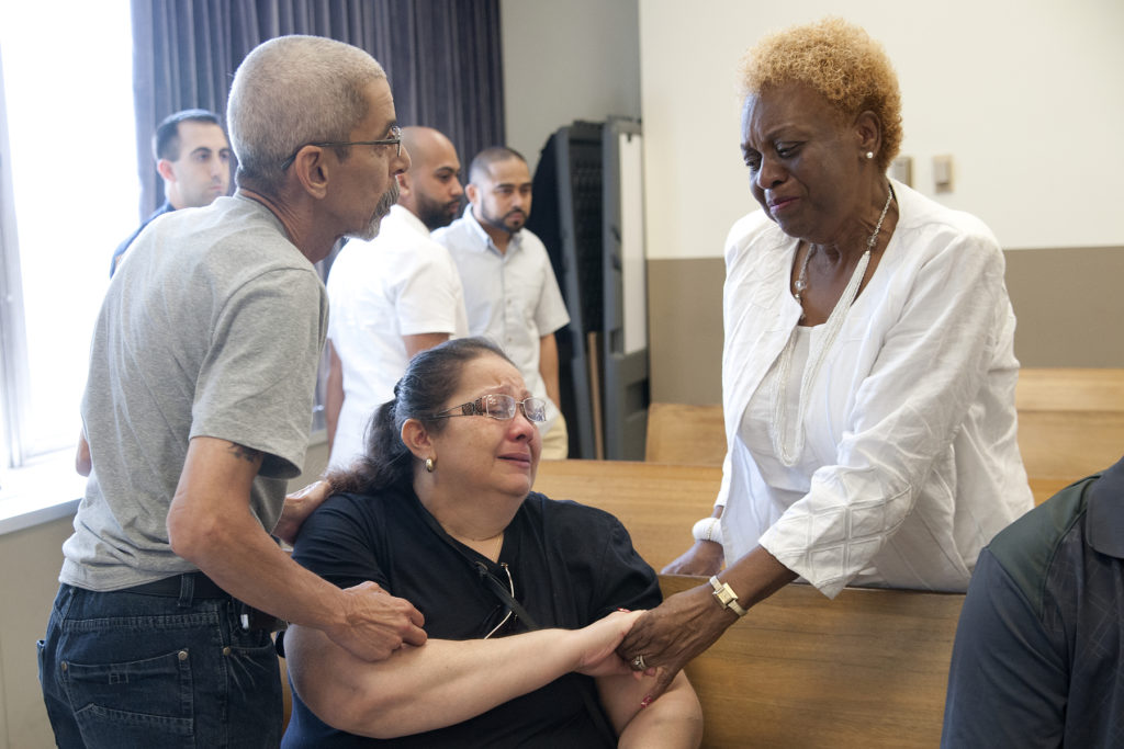 After the sentencing, grieving family members and friends of the vehicular homicide victim, Ron Hill II, and convicted killer, Luis E. Garcia, crossed the courtroom aisle and hugged and cried in each other's arms, offering each other condolences, on Friday, June 26, 2015. Pictured is Hill's grandmother, Hattie Hill Spry, right, offering her hand to Garcia's family. Reena Rose Sibayan | The Jersey Journal