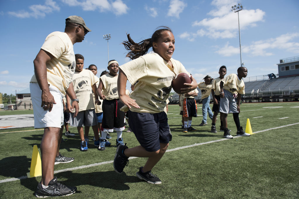 Daisy Santiago, 9, of Bayonne, participates in Coach Richard Glover's 13th annual All Access to Life Football Camp at the Ed "Faa" Ford Athletic Complex at Caven Point in Jersey City on Friday, July 10, 2015. More girls, about 5 of them, have participated in the camp this year than in previous years. Reena Rose Sibayan | The Jersey Journal