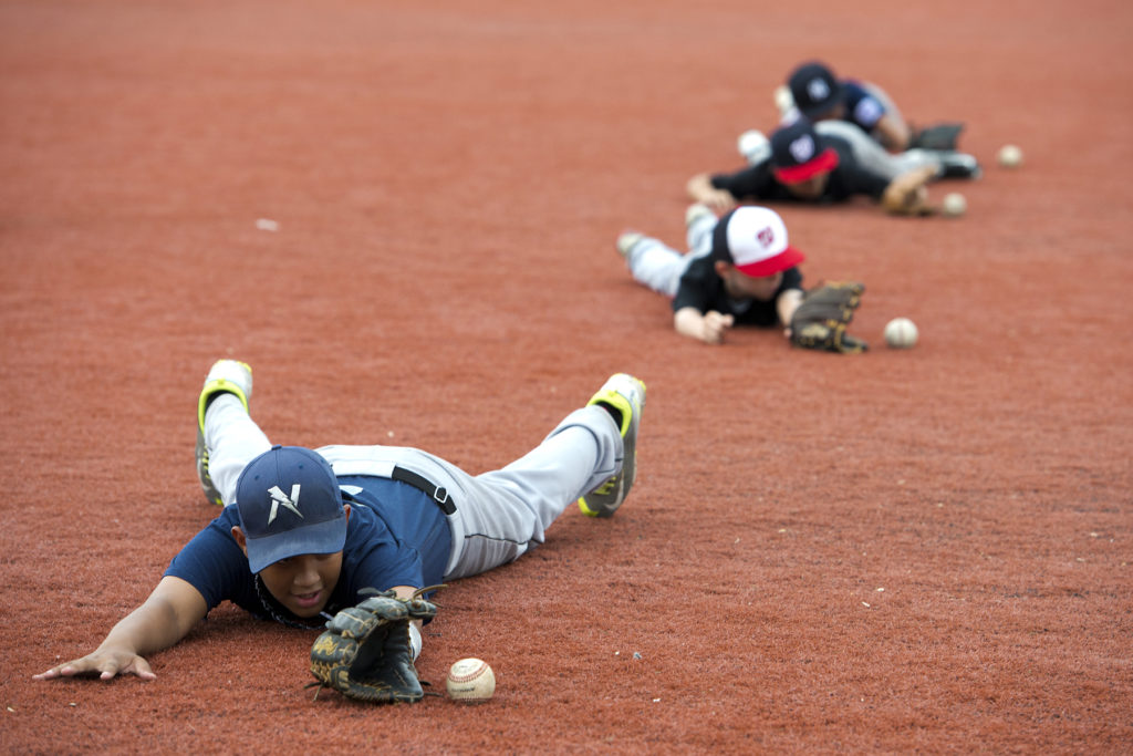 Boys ages 8 to 15 years old participate in the St. Peter's Prep Baseball Skills Camp at the Ed "Faa" Ford Athletic Complex at Caven Point in Jersey City on Tuesday, July 14, 2015. Reena Rose Sibayan | The Jersey Journal