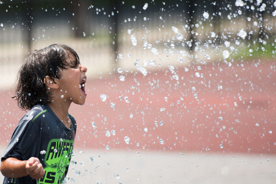 Adam Amrani, 5, tries to catch water in his mouth as he plays at the Pershing Field sprinkle park in Jersey City during a sizzling hot summer day with temperatures reaching the low 90s, Wednesday, July 29, 2015. Reena Rose Sibayan | The Jersey Journal