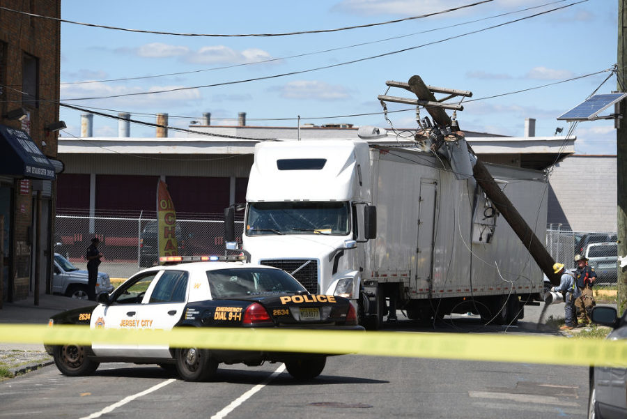 A tractor trailer crashes into a utility pole on Logan Avenue at Freeman Avenue in Jersey City, knocking out power in the area on Friday, Aug. 28, 2015. Reena Rose Sibayan | The Jersey Journal
