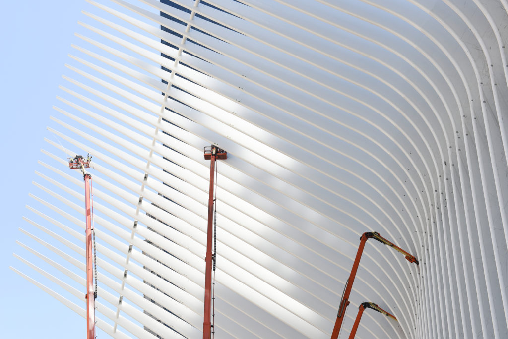 Using roller brushes, workers paint the 'wings' of the World Trade Center Transportation Hub in New York City which is still under construction, Wednesday, Sept. 23, 2015. Reena Rose Sibayan | The Jersey Journal