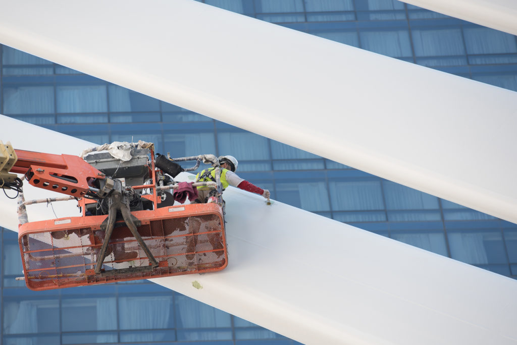A worker paints the 'wings' of the World Trade Center Transportation Hub in New York City which is still under construction, Wednesday, Sept. 23, 2015. Reena Rose Sibayan | The Jersey Journal