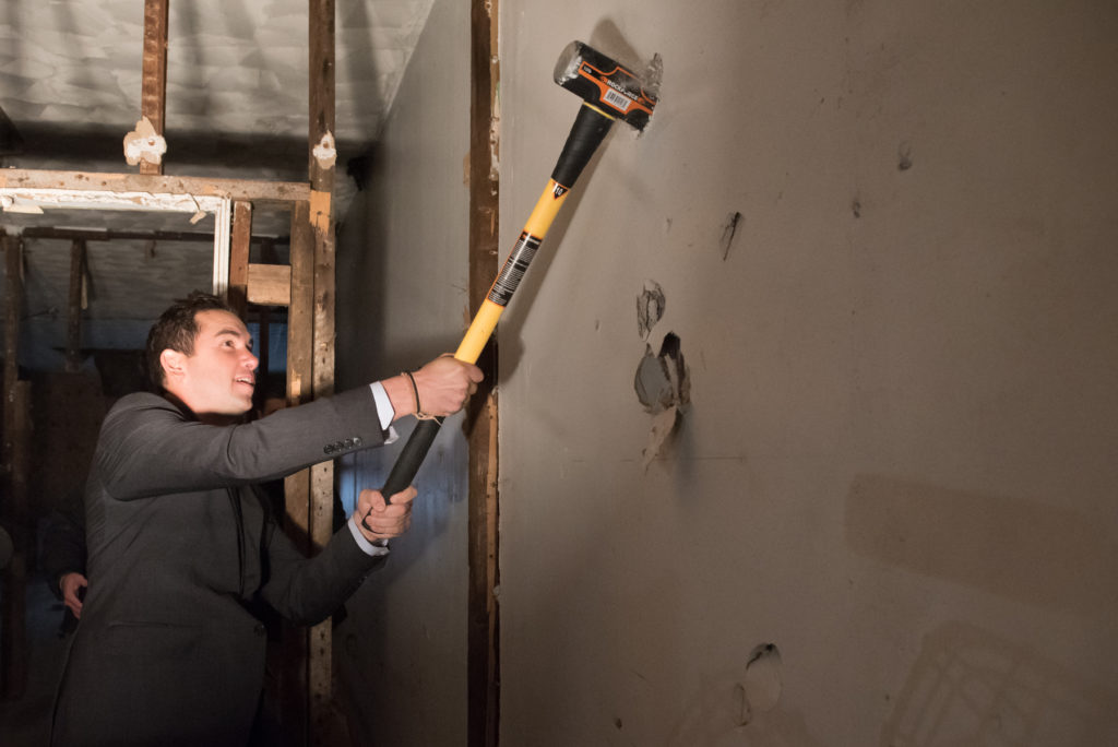 Officials used a sledgehammer to pound on a Jersey City building which will be demolished in order to erect an eight-unit building for homeless veterans on Ocean Avenue during a groundbreaking ceremony on Veterans Day, Wednesday, Nov. 11, 2015. Reena Rose Sibayan | The Jersey Journal