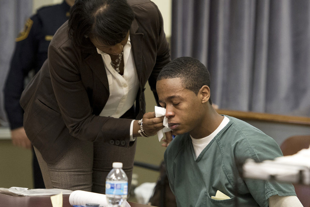 Lawyer Adrienne Edward wipes the tears off Robert Warren's face after his father and grandmother addressed the court during his sentencing on Friday, Feb 19, 2016, on a 2014 North Bergen carjacking and armed burglary. Reena Rose Sibayan | The Jersey Journal