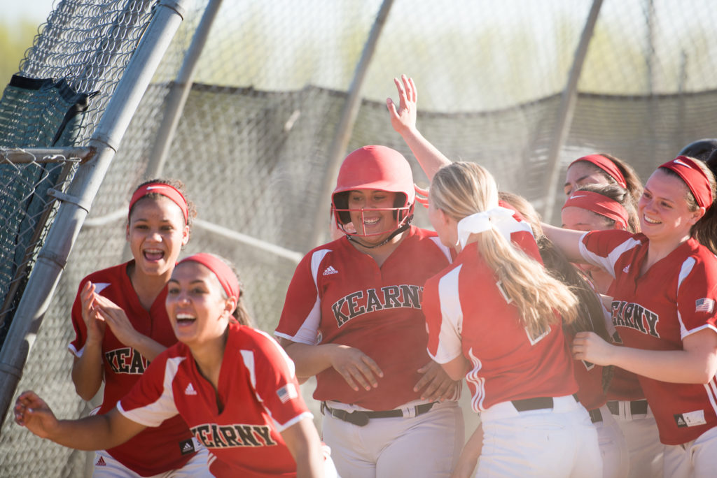 Kearny's Tatiana Ferment, center, is mobbed by jubilant teammates after scoring a two-run home run during the game against North Bergen at Gunnell Oval in Kearny on Wednesday, April 20, 2016. Reena Rose Sibayan | The Jersey Journal