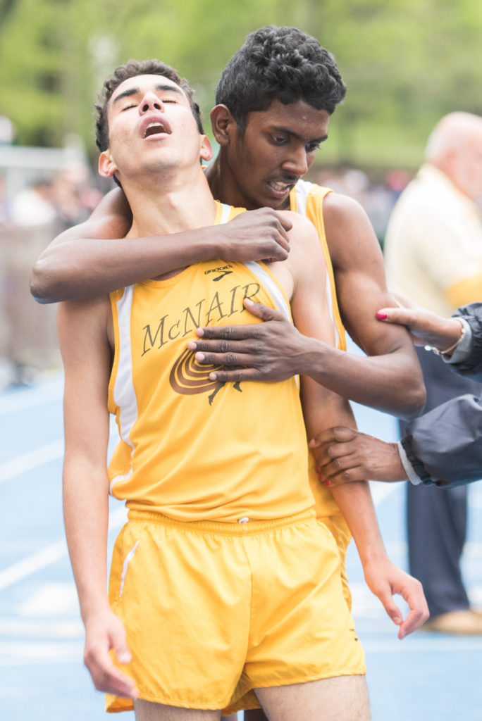McNair Academic's Fahd Nasser embraces teammate Younass Barkouch at the finish line after they placed third and second, respectively, in the boys 3200-meter race during the 2016 Jersey City Outdoor Track & Field Championship at Stephen R. Gregg Park in Bayonne on Tuesday, May 3, 2016. Reena Rose Sibayan | The Jersey Journal