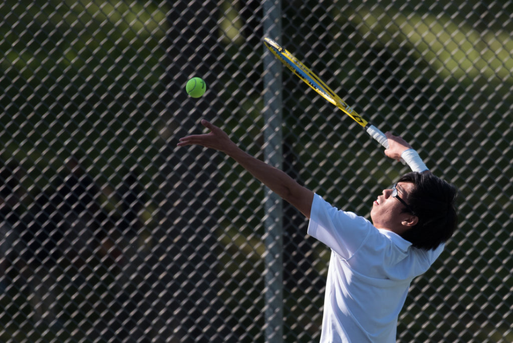 Harrison's Alan Yucompetes in the first singles match against Kearny's Jason Boyle during the Hudson County team tennis tournament quarterfinals at West Hudson Park in Kearny on Friday, May 20, 2016. Reena Rose Sibayan | The Jersey Journal