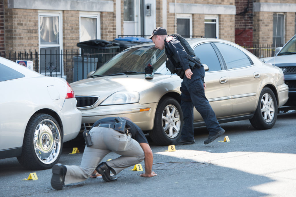 Jersey City police officers investigate a shooting on Forrest Street near Martin Luther King Drive on Thursday afternoon, Aug. 4, 2016. Reena Rose Sibayan | The Jersey Journal