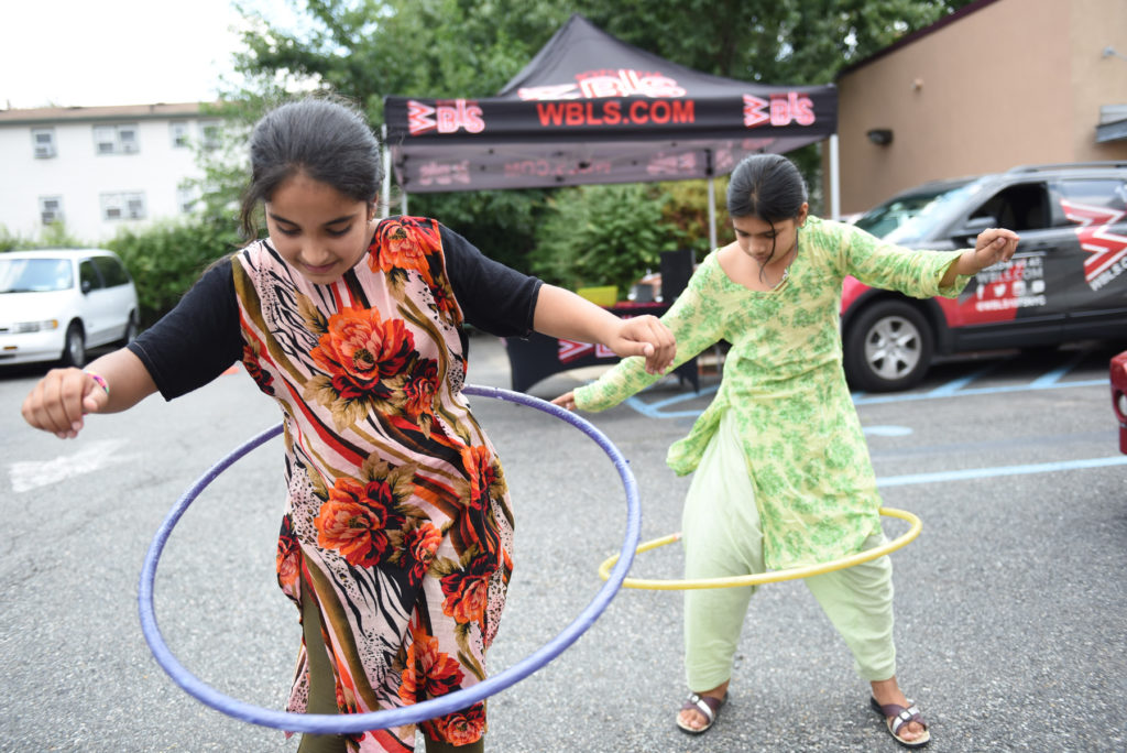 The Jersey City Education Association (JCEA) holds a back-to-school drive giving away book bags filled with school supplies that were donated by city residents to kids on Friday, Aug. 19, 2016. Parents and their children enjoyed free hotdogs from Relish the Thought and kids competed in a hula hoop contest and danced to music played by DJ Sir Trey Benjamin from 107.5 FM WBLS. Reena Rose Sibayan | The Jersey Journal