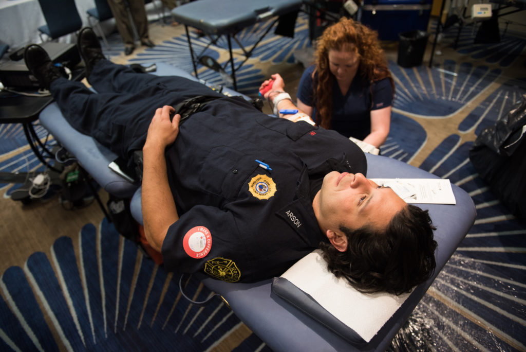 The American Red Cross Penn-Jersey Blood Services Region holds the Jersey City Police & Fire 2nd Annual 9/11 Memorial Blood Drive at the Hyatt Regency Hotel on Monday, Sept. 12, 2016. Here, Jersey City Firefighter Christian Sir donates blood. Reena Rose Sibayan | The Jersey Journal