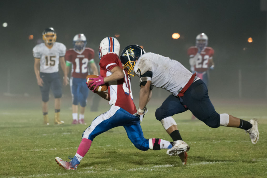Saddle Brook's Andrew Lorenzo stops Secaucus' Jaden Gonzalez from running with the ball that he picked up after an incomplete pass during the football game on Friday, Oct. 21, 2016. Reena Rose Sibayan | The Jersey Journal