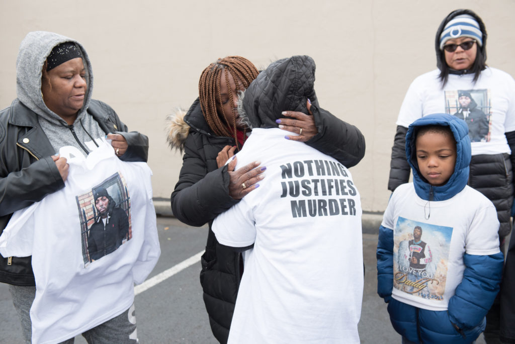 Tyreek McCord's family, along with his three young children and led by his mother, Annie (in red), marked the anniversary of his death on Monday, Nov. 21, 2016, by walking from his home on Yale Avenue to the IHOP Restaurant on Route 440 in Jersey City where he was fatally shot in the parking lot. They lit candles, prayed and released balloons in his memory and also voiced their dismay and frustration that a year later, no murder charges have been filed against the suspects arrested in the case. Here, Annie McCord consoles her granddaughter, Tyasia, 9. Reena Rose Sibayan | The Jersey Journal