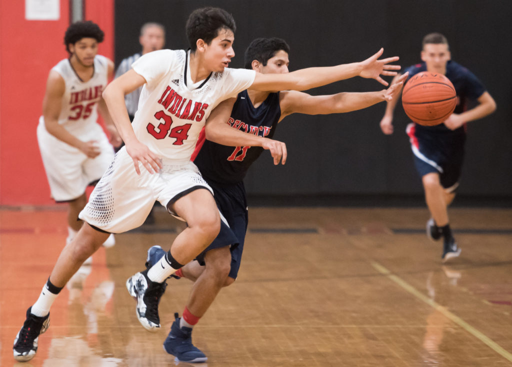 Weehawken hosts Secaucus during the Indian Classic Christmas Tournament boys basketball game on Tuesday, Dec. 27, 2016. Secaucus won, 45-31. Pictured are Weehawken's Alessandro Romano (34) and Secaucus' Abu Ahmed. Reena Rose Sibayan | The Jersey Journal