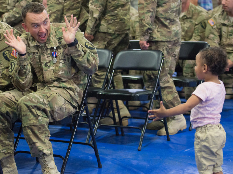 Ssgt. Guy Luerssen, 29, of Brooklyn, plays peek-a-boo with his two-year-old son, Oliver. Families and dignitaries welcome home 160 soldiers of the New Jersey Army National Guard